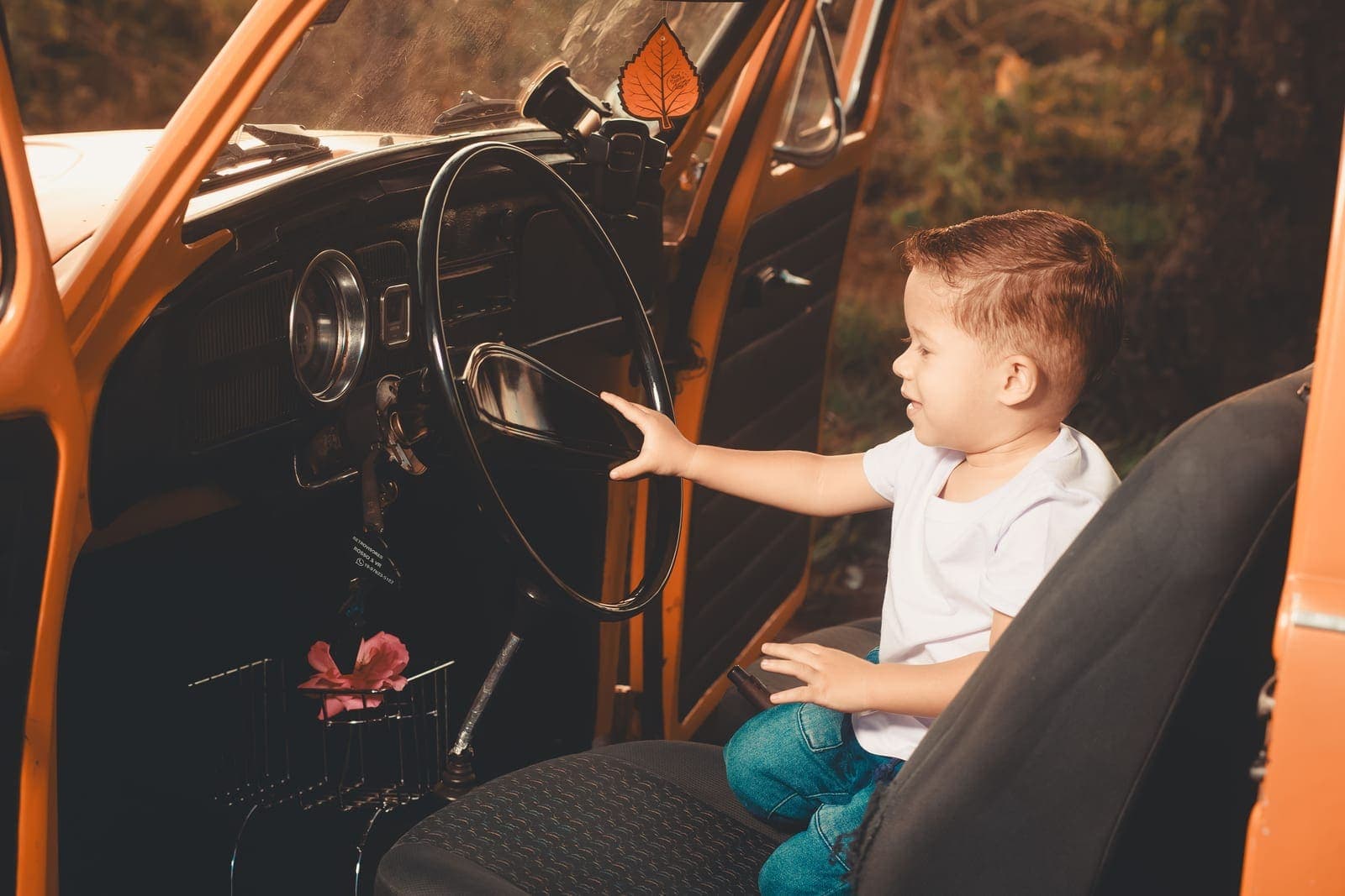 A child secured in a car seat in the back of a vehicle