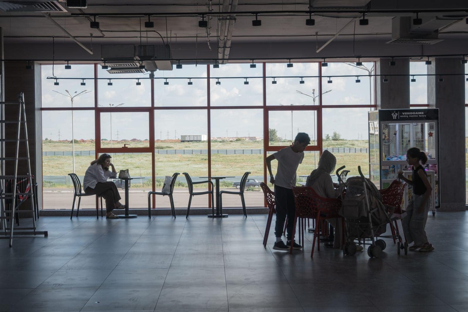 A family walking through an airport terminal with luggage